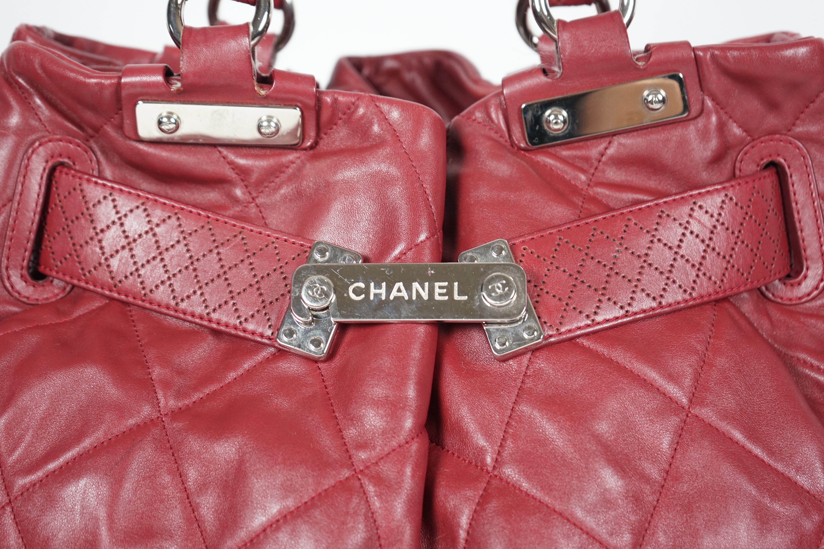 A Chanel burgundy leather buckled handle bag, with dust bag, width 45cm, height: 24.5cm, height overall 44cm, depth 16.5cm, Please note this lot attracts an additional import tax of 20% on the hammer price